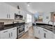 Modern kitchen featuring white cabinets, granite counters, and stainless steel appliances at 6817 Frances Celia Ave, Las Vegas, NV 89122