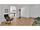 Bright living room featuring wood-look floors, neutral paint, and an open floor plan to the kitchen at 6817 Frances Celia Ave, Las Vegas, NV 89122