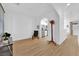 Bright living room featuring wood-look floors, neutral paint, and an open floor plan to the kitchen at 6817 Frances Celia Ave, Las Vegas, NV 89122