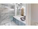 Stylish bathroom with marble walls, sleek vanity, and a glass-enclosed shower at 6944 Emerald Springs Ln, Las Vegas, NV 89113