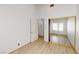 Bedroom featuring bright wood laminate floors, closet, and window at 6944 Emerald Springs Ln, Las Vegas, NV 89113