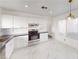 Bright kitchen with stainless steel appliances, stone countertops, and marble tile floors at 6944 Emerald Springs Ln, Las Vegas, NV 89113