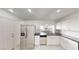 Bright kitchen featuring stainless steel appliances, white cabinets, and a tiled backsplash at 6944 Emerald Springs Ln, Las Vegas, NV 89113
