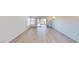 Open living room with sliding door to backyard and bright wood laminate flooring at 6944 Emerald Springs Ln, Las Vegas, NV 89113