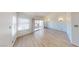 Spacious living room with sliding glass doors and wood-look flooring at 6944 Emerald Springs Ln, Las Vegas, NV 89113