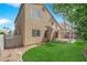 Exterior view of the home with a well-maintained lawn and a shaded pergola area at 7213 Buglehorn St, Las Vegas, NV 89131