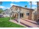 Manicured backyard featuring a pergola, brick patio, and lush green lawn at 7213 Buglehorn St, Las Vegas, NV 89131