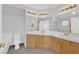Bright bathroom featuring dual sinks, a large vanity mirror, and ample counter space at 7213 Buglehorn St, Las Vegas, NV 89131