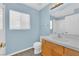 Bathroom featuring a vanity, toilet, mirror, and window at 7213 Buglehorn St, Las Vegas, NV 89131