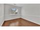 Light-filled bedroom with neutral walls, laminate floors, and a large window at 7213 Buglehorn St, Las Vegas, NV 89131