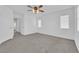 Bright bedroom features plush carpet, ceiling fan, neutral walls, and multiple windows at 7213 Buglehorn St, Las Vegas, NV 89131