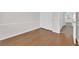 Bedroom showcasing neutral walls, laminate floors, and doorway to hall at 7213 Buglehorn St, Las Vegas, NV 89131