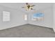 Spacious, carpeted bedroom with a ceiling fan and large window offering abundant natural light at 7213 Buglehorn St, Las Vegas, NV 89131