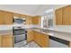 Kitchen boasts stainless steel appliances and bright light from the window at 7213 Buglehorn St, Las Vegas, NV 89131