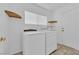 Laundry room featuring a washing machine, dryer, shelves, and a door at 7213 Buglehorn St, Las Vegas, NV 89131