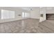 Spacious living room with vaulted ceiling, tile floors, natural light, and staircase to the upper level at 7213 Buglehorn St, Las Vegas, NV 89131