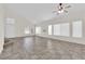 Spacious living room with vaulted ceiling, tile floors, natural light, and staircase to the upper level at 7213 Buglehorn St, Las Vegas, NV 89131