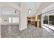 Living room and kitchen area with tile floors, stainless appliances and open floorplan at 7213 Buglehorn St, Las Vegas, NV 89131