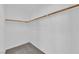 Bright walk-in closet with wooden clothing rods and white walls provides efficient storage space at 7213 Buglehorn St, Las Vegas, NV 89131