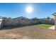 Backyard featuring a patch of well-maintained artificial turf, rock landscaping, and block wall privacy fencing at 7437 Lattimore Dr, Las Vegas, NV 89128