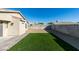 Spacious backyard featuring artificial turf, rock landscaping, brick patio and block wall privacy fencing at 7437 Lattimore Dr, Las Vegas, NV 89128
