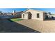 Wide shot of a backyard featuring artificial turf, rock landscaping, brick patio and block wall privacy fencing at 7437 Lattimore Dr, Las Vegas, NV 89128