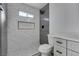 Modern bathroom featuring marble-look tile and a sleek, glass-enclosed shower with gray tile accents at 7437 Lattimore Dr, Las Vegas, NV 89128
