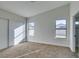 Bright bedroom with neutral carpet, two double pane windows, and a closet with sliding doors at 7437 Lattimore Dr, Las Vegas, NV 89128