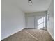 A bright bedroom featuring a double pane window, neutral carpet and a sliding door closet at 7437 Lattimore Dr, Las Vegas, NV 89128