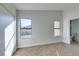 Bedroom with neutral carpet, a double door closet and two windows with backyard views at 7437 Lattimore Dr, Las Vegas, NV 89128