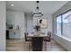This dining room is virtually staged and includes a chandelier and many windows at 7437 Lattimore Dr, Las Vegas, NV 89128