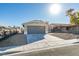 Charming single-story home with a two-car garage, desert landscaping, and a well-maintained lawn at 7437 Lattimore Dr, Las Vegas, NV 89128