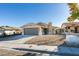 Charming single-story home with a two-car garage, desert landscaping, and a well-maintained lawn at 7437 Lattimore Dr, Las Vegas, NV 89128
