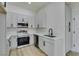 Modern kitchen features stainless steel appliances, gray cabinets, and quartz countertops at 7437 Lattimore Dr, Las Vegas, NV 89128