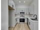 This kitchen features stainless steel appliances, light gray cabinets, and a wood floor at 7437 Lattimore Dr, Las Vegas, NV 89128