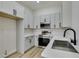 Well-equipped kitchen featuring gray cabinets, stainless steel appliances, and modern hardware at 7437 Lattimore Dr, Las Vegas, NV 89128