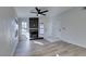 Bright living room showcasing sleek fireplace, wood-look flooring, and two entry doors at 7437 Lattimore Dr, Las Vegas, NV 89128