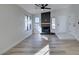 Inviting living room featuring modern fireplace, wood-look floors, and lots of natural light at 7437 Lattimore Dr, Las Vegas, NV 89128