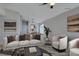 This living room is virtually staged and includes a sofa, chairs, and a chandelier in the next room at 7437 Lattimore Dr, Las Vegas, NV 89128