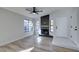 Spacious living room with a sleek fireplace, wood-look flooring, and ample natural light at 7437 Lattimore Dr, Las Vegas, NV 89128