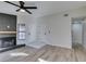 Living room with a modern fireplace, wood-look flooring, and entry to other rooms at 7437 Lattimore Dr, Las Vegas, NV 89128