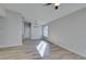 This living room is empty with wood floors, a chandelier, and an entrance to a kitchen at 7437 Lattimore Dr, Las Vegas, NV 89128