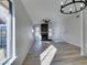 Bright living room with a fireplace, wood-look floors, and modern light fixture at 7437 Lattimore Dr, Las Vegas, NV 89128
