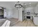 Open living space featuring modern kitchen, fireplace, and wood-look floors at 7437 Lattimore Dr, Las Vegas, NV 89128