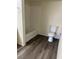 Bathroom featuring gray wood-look floors, tub and shower with white tile at 8101 W Flamingo Rd # 1073, Las Vegas, NV 89147