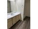 Bathroom with gray wood-look floors and a large vanity at 8101 W Flamingo Rd # 1073, Las Vegas, NV 89147