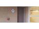 Apartment front entrance with unit number, fire alarm, and exterior window with natural light at 8101 W Flamingo Rd # 1073, Las Vegas, NV 89147