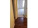 View from wood-look hallway into a carpeted room with an open door at 8101 W Flamingo Rd # 1073, Las Vegas, NV 89147