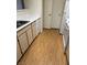 Apartment kitchen with a white dishwasher and countertops, with wood floor at 8101 W Flamingo Rd # 1073, Las Vegas, NV 89147