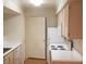 Functional kitchen with white appliances, light wood cabinets, and tile countertops at 8101 W Flamingo Rd # 1073, Las Vegas, NV 89147